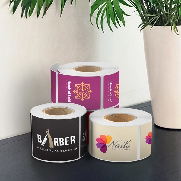 Roll of custom labels on a table, various shapes and sizes, versatile labeling solutions